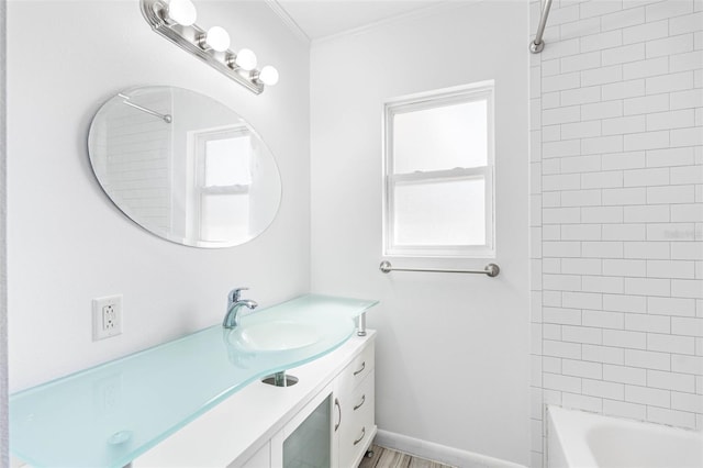 bathroom featuring vanity, crown molding, and tiled shower / bath combo