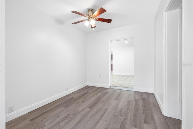 spare room featuring light hardwood / wood-style flooring and ceiling fan