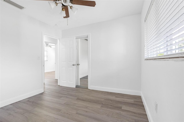 empty room featuring ceiling fan and light wood-type flooring