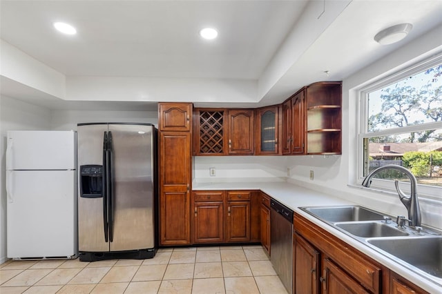 kitchen featuring sink, light tile patterned flooring, and stainless steel appliances