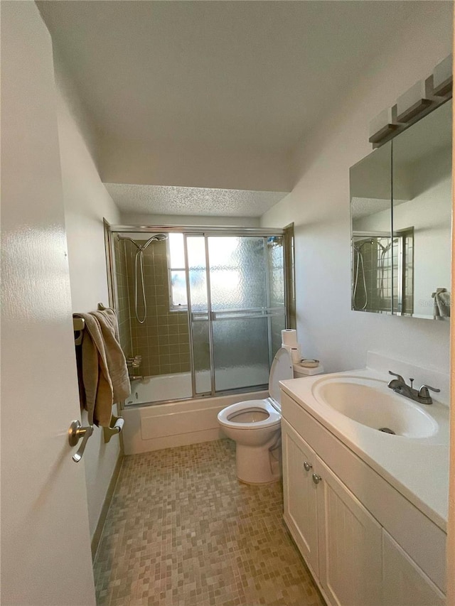 full bathroom with vanity, enclosed tub / shower combo, and toilet