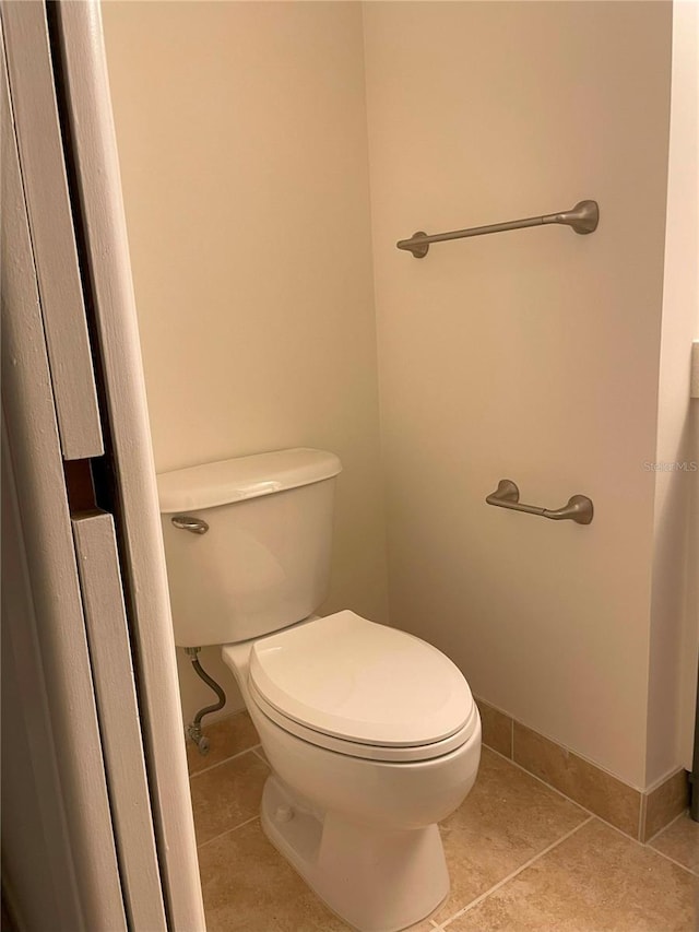 bathroom featuring toilet and tile patterned floors