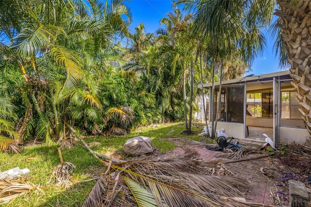 view of yard with a sunroom