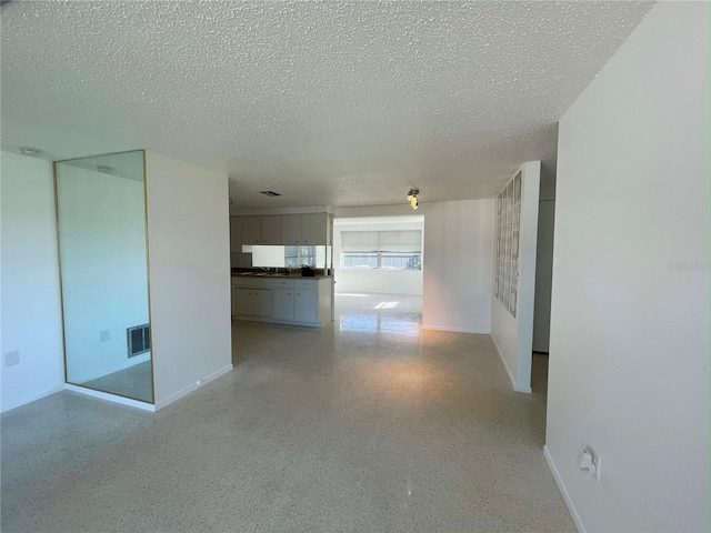 unfurnished room featuring a textured ceiling