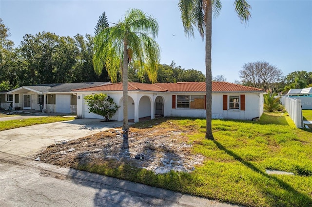 view of front of home with a front yard and a garage