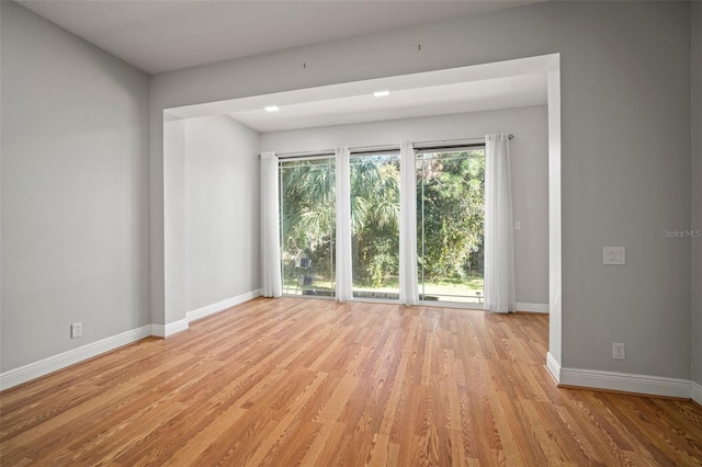 unfurnished room with light wood-type flooring