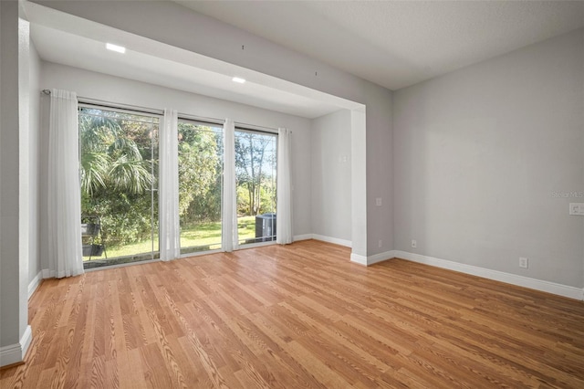 empty room with light hardwood / wood-style flooring