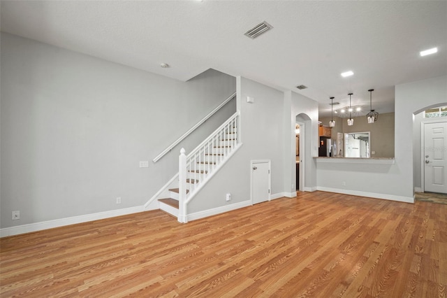 unfurnished living room featuring light hardwood / wood-style floors