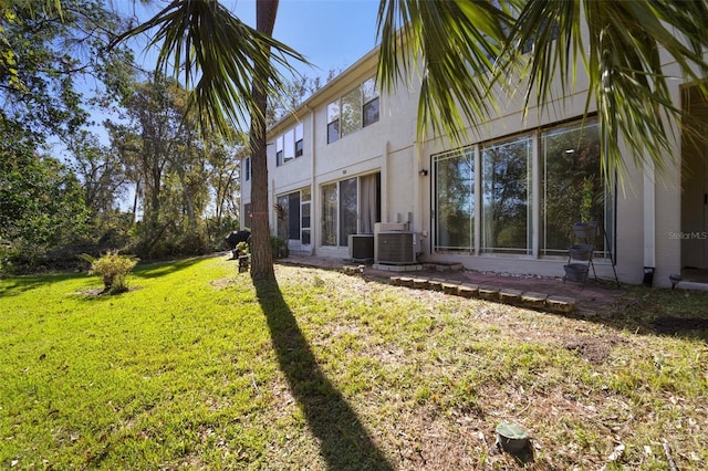 exterior space featuring a lawn and cooling unit