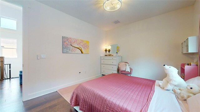 bedroom with dark wood-type flooring