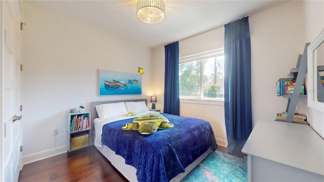 bedroom with dark wood-type flooring