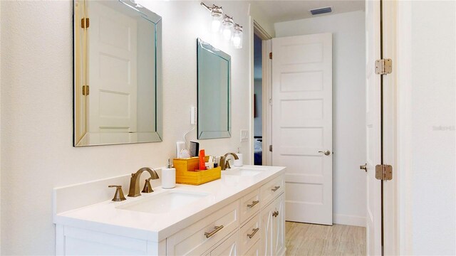 bathroom with vanity and hardwood / wood-style floors