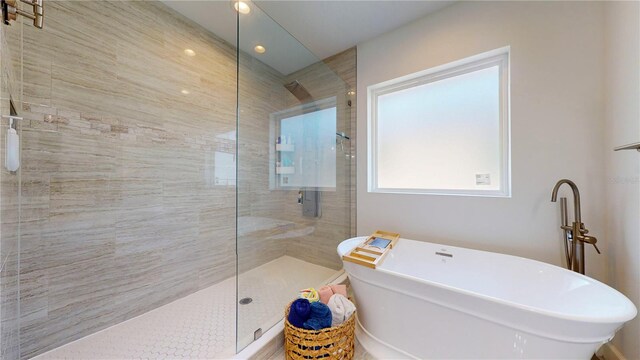 bathroom with separate shower and tub