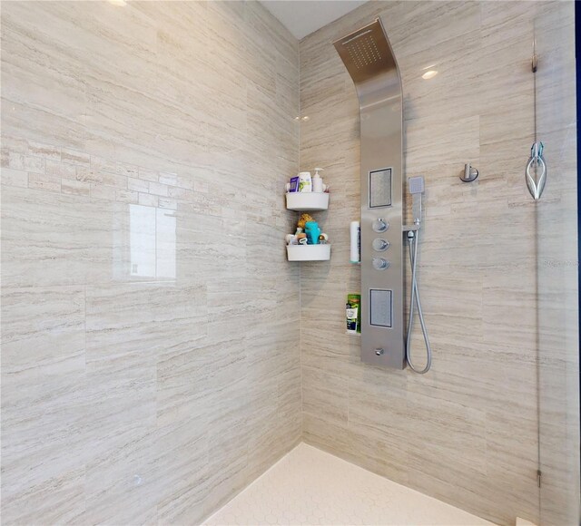 bathroom with a tile shower