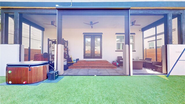 property entrance with a patio, french doors, a lawn, and ceiling fan