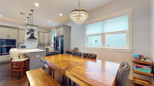 dining space featuring a chandelier and dark wood-type flooring