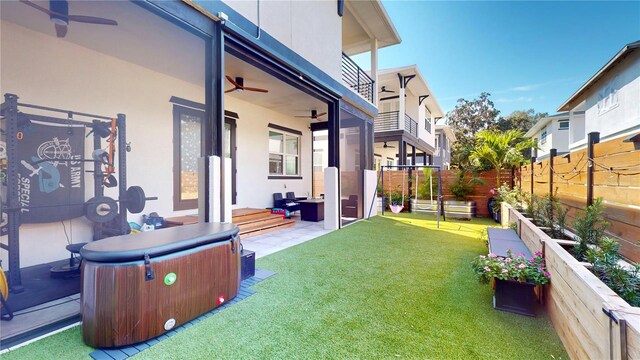 view of yard with a balcony, a patio area, and ceiling fan