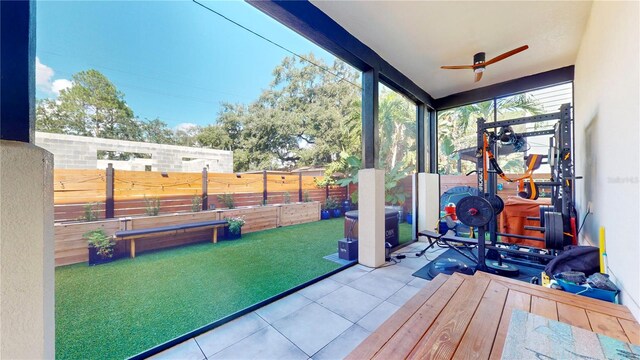 sunroom / solarium featuring ceiling fan