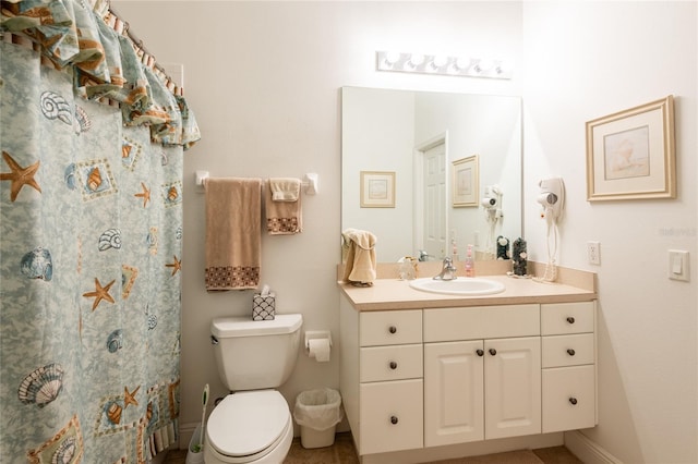 bathroom featuring vanity, toilet, and a shower with curtain