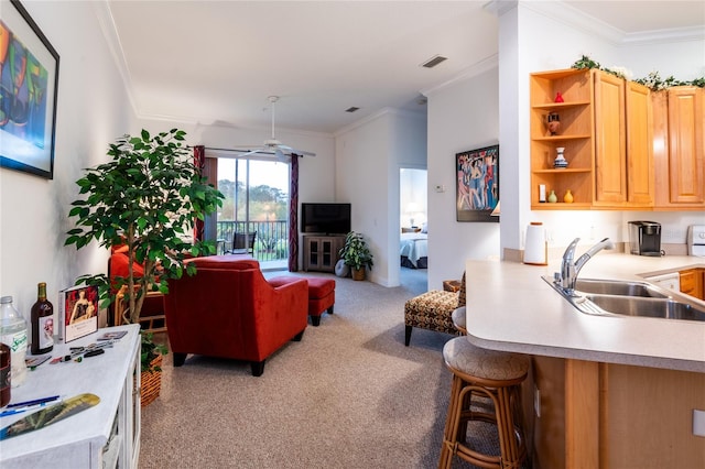 carpeted living room with crown molding, sink, and ceiling fan