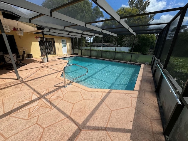 view of swimming pool featuring a fenced in pool, a lanai, and a patio area