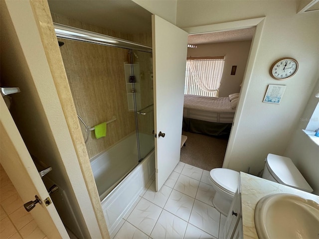 full bathroom featuring tile patterned flooring, vanity, toilet, and bath / shower combo with glass door