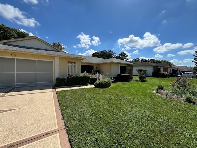 single story home with a front yard and a garage