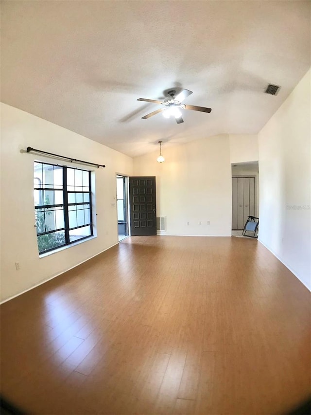 unfurnished living room featuring a textured ceiling, hardwood / wood-style floors, and ceiling fan