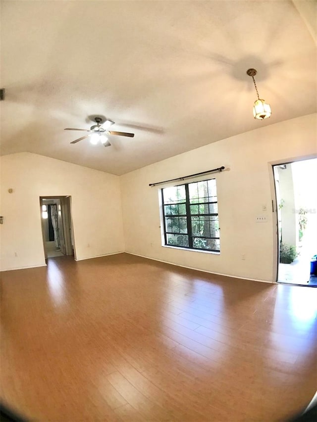 unfurnished living room with wood-type flooring, ceiling fan, and vaulted ceiling