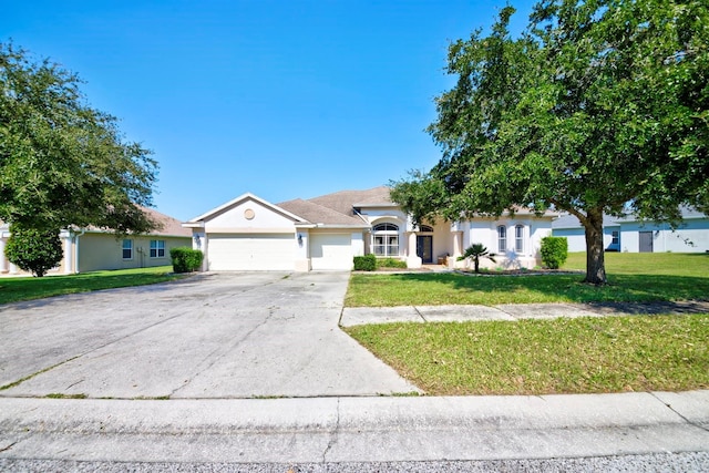 ranch-style house featuring a garage and a front lawn