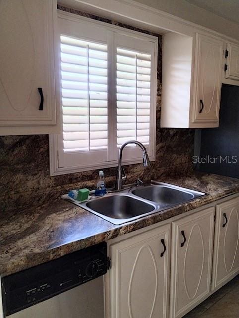 kitchen with a wealth of natural light, sink, dishwasher, and white cabinets