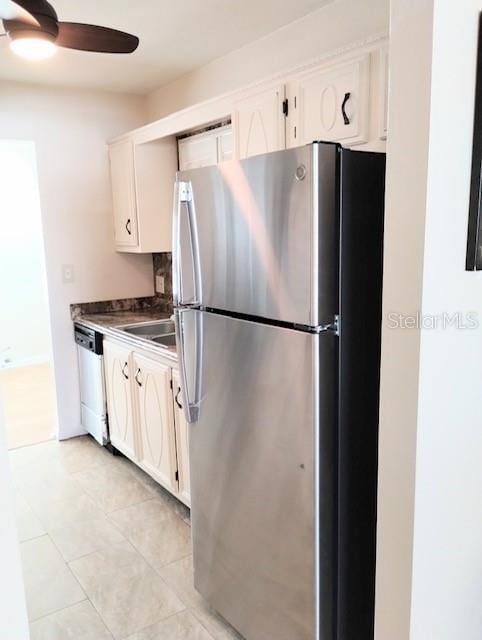 kitchen featuring dishwasher, stainless steel fridge, ceiling fan, white cabinets, and light tile patterned floors