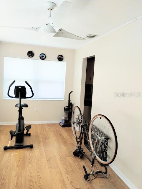 workout room featuring light hardwood / wood-style floors