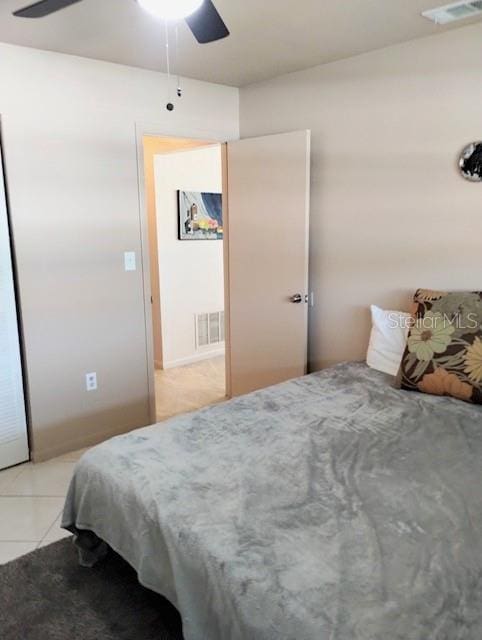 bedroom with light tile patterned flooring and ceiling fan