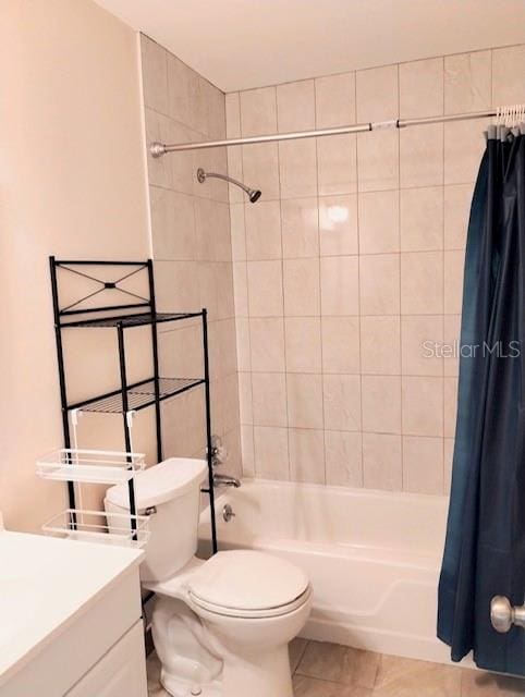 full bathroom with vanity, toilet, shower / bath combo with shower curtain, and tile patterned flooring