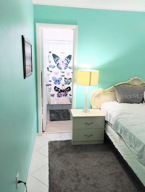 bedroom with light tile patterned flooring