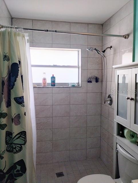 bathroom featuring toilet and walk in shower