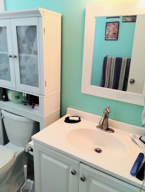 bathroom with toilet and vanity