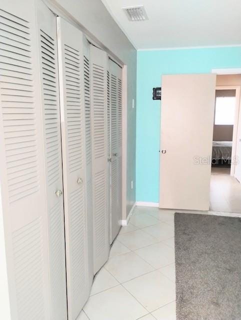 hall featuring light tile patterned flooring