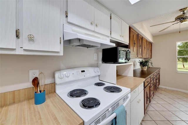 kitchen with electric range, ceiling fan, light tile patterned floors, a textured ceiling, and white cabinets