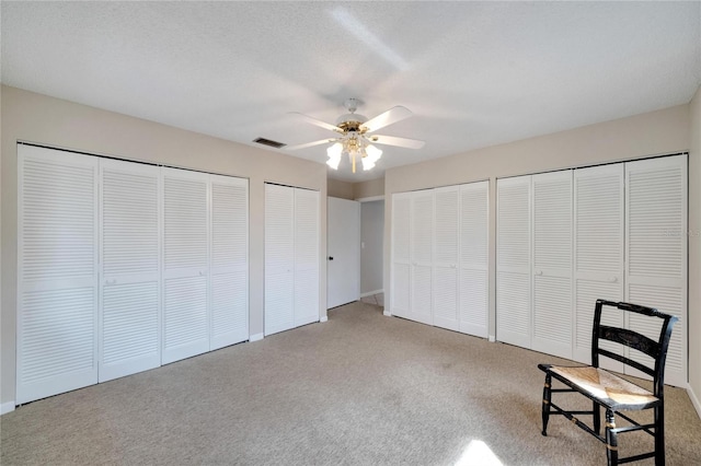 unfurnished room with carpet, a textured ceiling, and ceiling fan