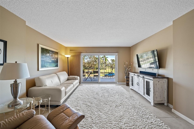 living room with a textured ceiling and light tile patterned floors