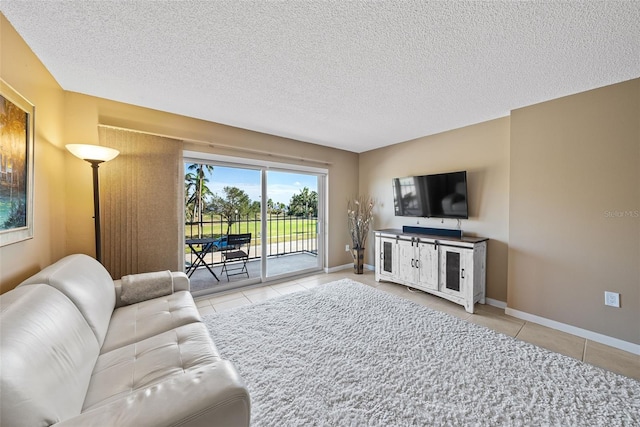 living room with light tile patterned floors and a textured ceiling