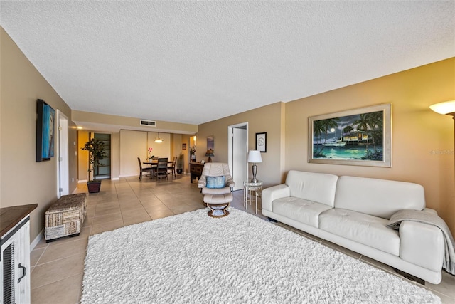 tiled living room with a textured ceiling