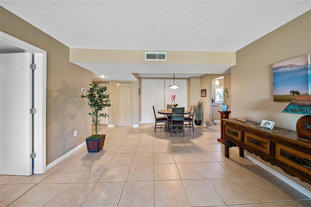 tiled entrance foyer with a textured ceiling