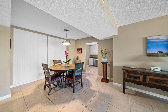 dining room featuring light tile patterned floors and a textured ceiling