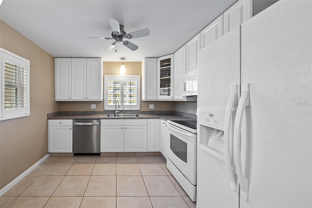 kitchen featuring white cabinetry, sink, white appliances, and light tile patterned flooring