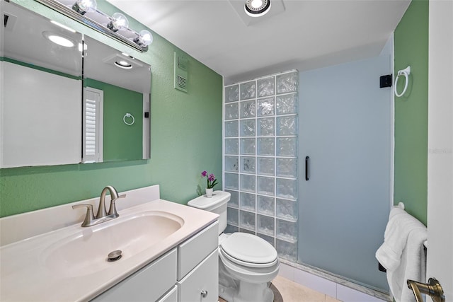 bathroom featuring vanity, an enclosed shower, tile patterned flooring, and toilet