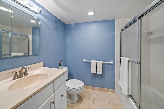 full bathroom with vanity, tile patterned floors, shower / bath combination with glass door, and toilet