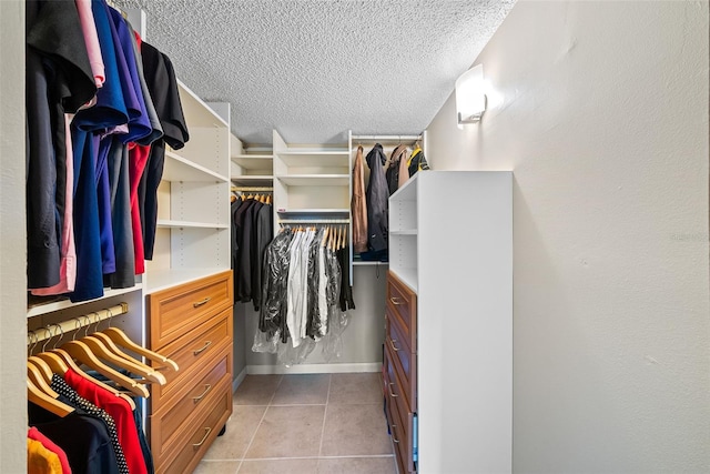 spacious closet with light tile patterned floors